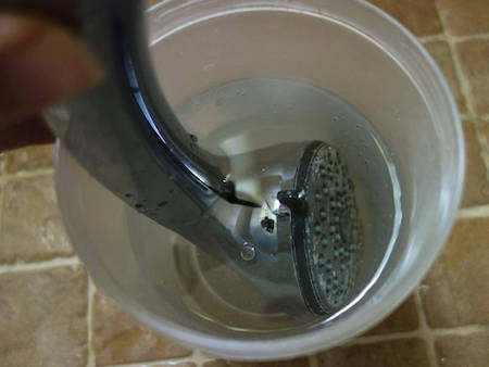 Soak the faceplate or showerhead in white vinegar for 8 hours